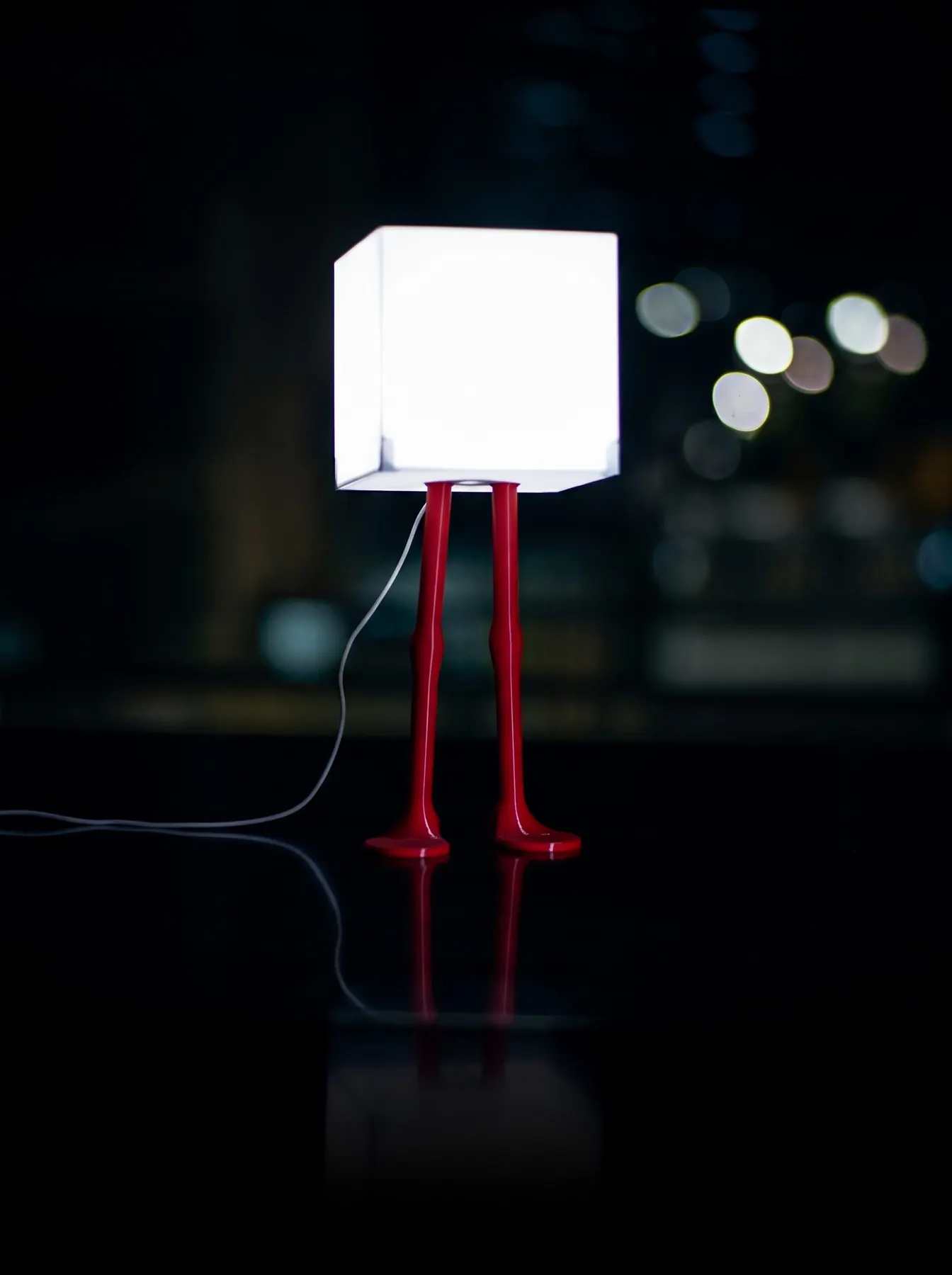 Flamingo Light, standing pose: a glowing cube shade on two red legs
