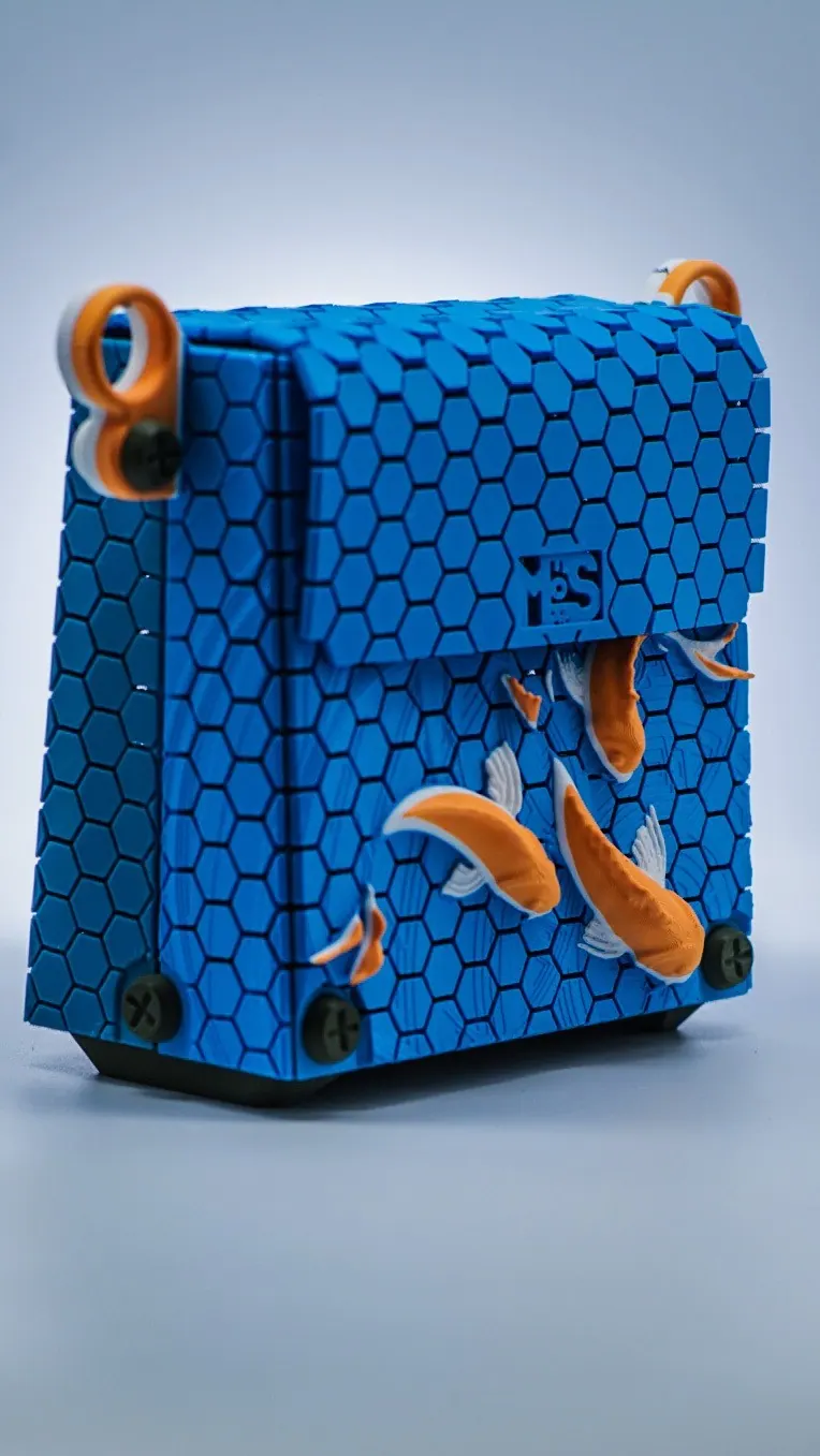 Blue hexagon-textured handbag with orange koi fish and orange rings, Handbag M · Koi Fish