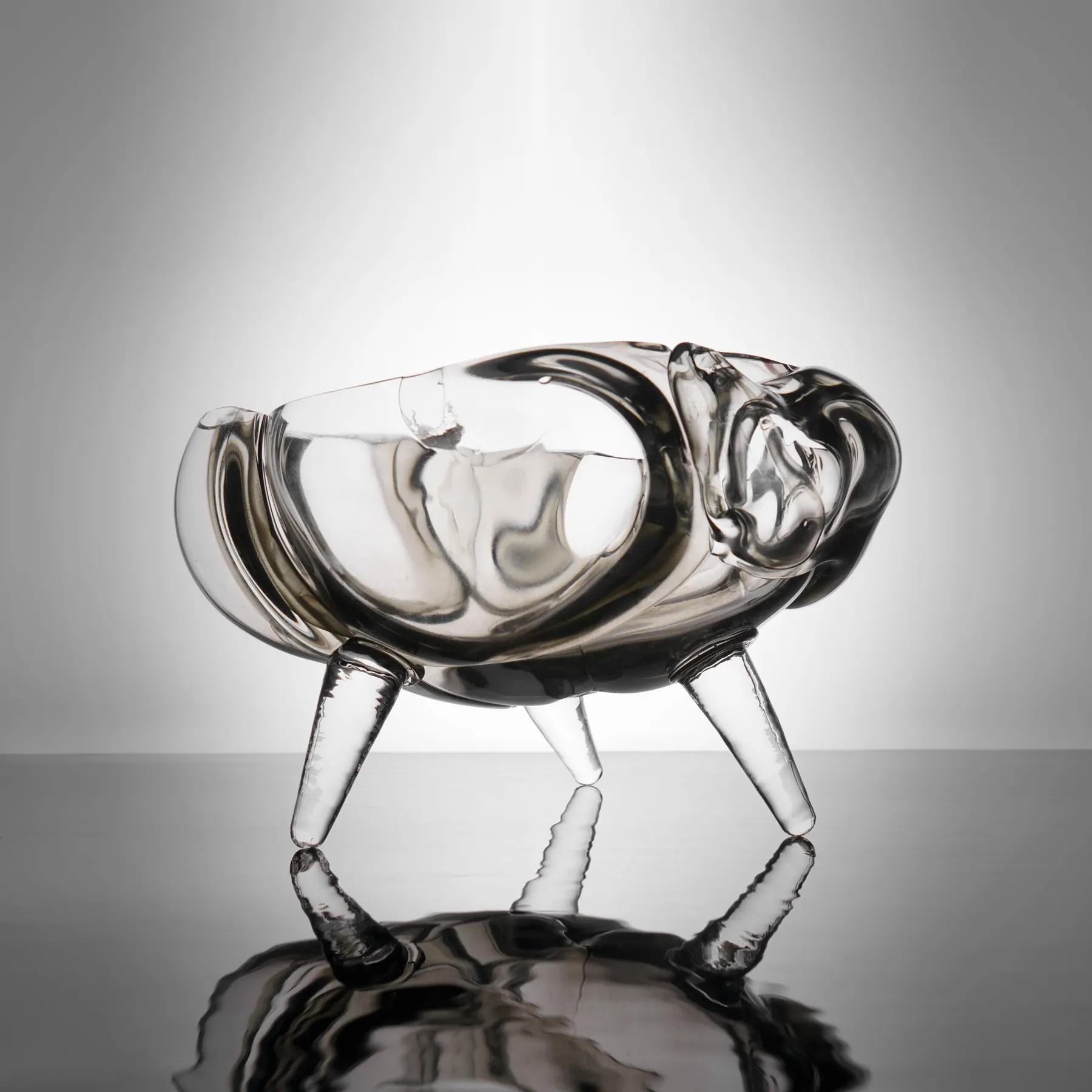Clear crystal bowl on three tapered legs with a softly curving rim, Crystal art pieces