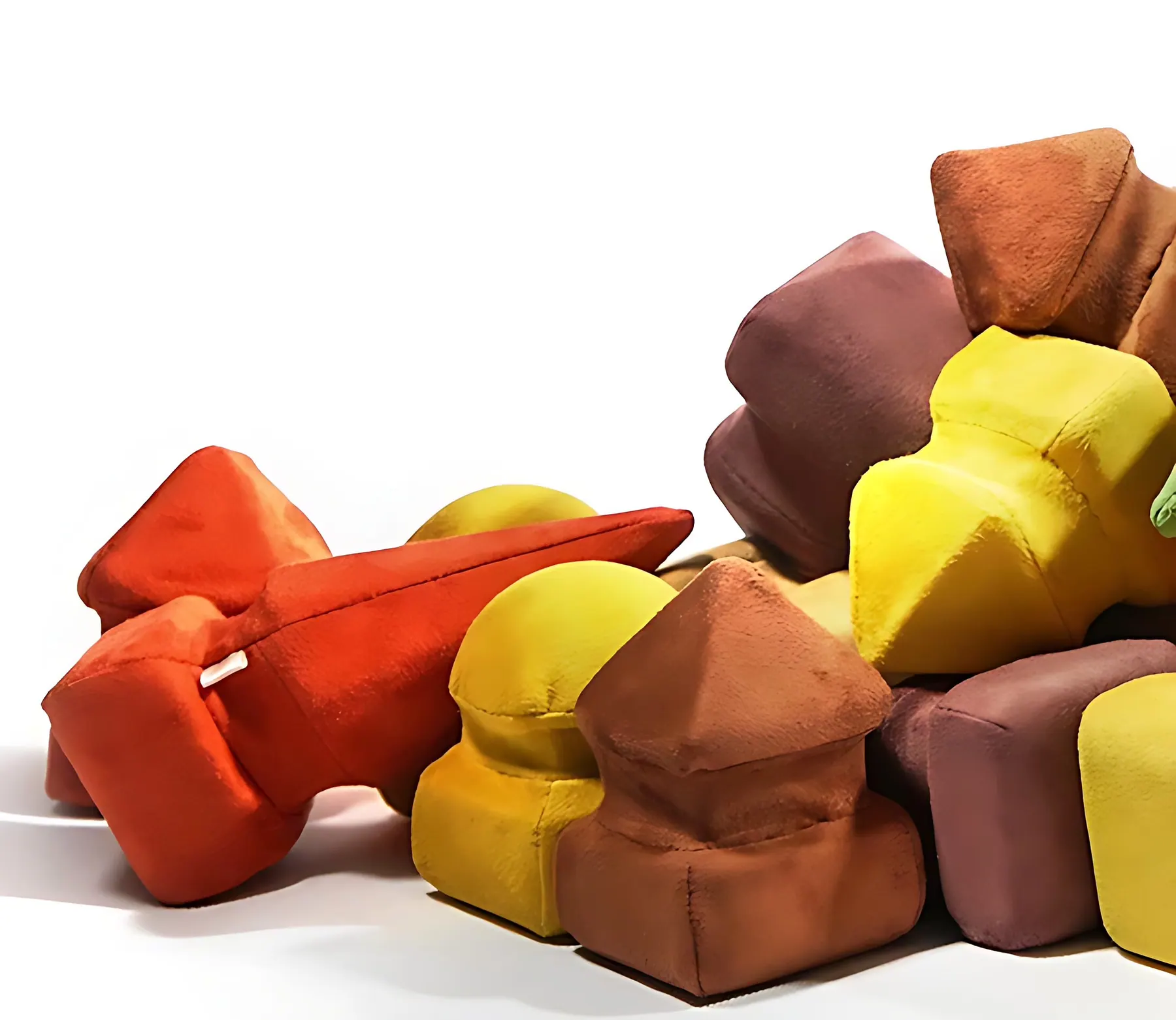 Pile of soft Morphit cushions in orange, mustard, brown and plum fabric