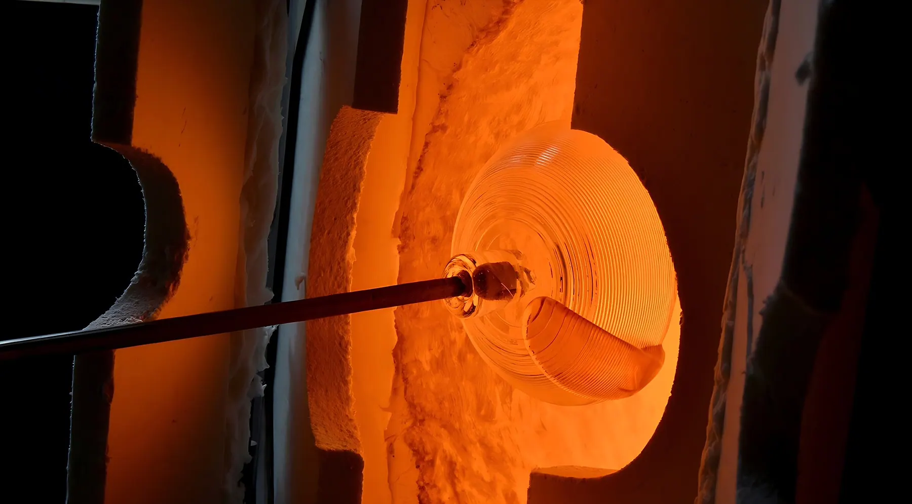 Glowing gather of molten glass on a blowpipe inside a glass furnace, Sipek Crystal