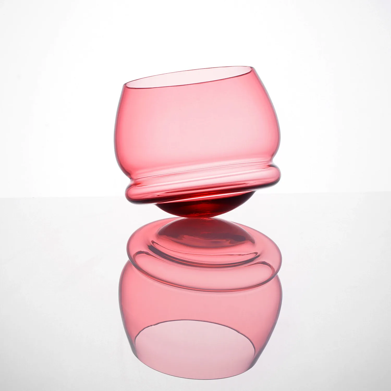 A rocking whiskey glass made from rose coloured crystal