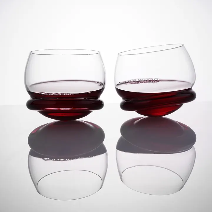 A rocking whiskey glass made from clear coloured crystal with wine