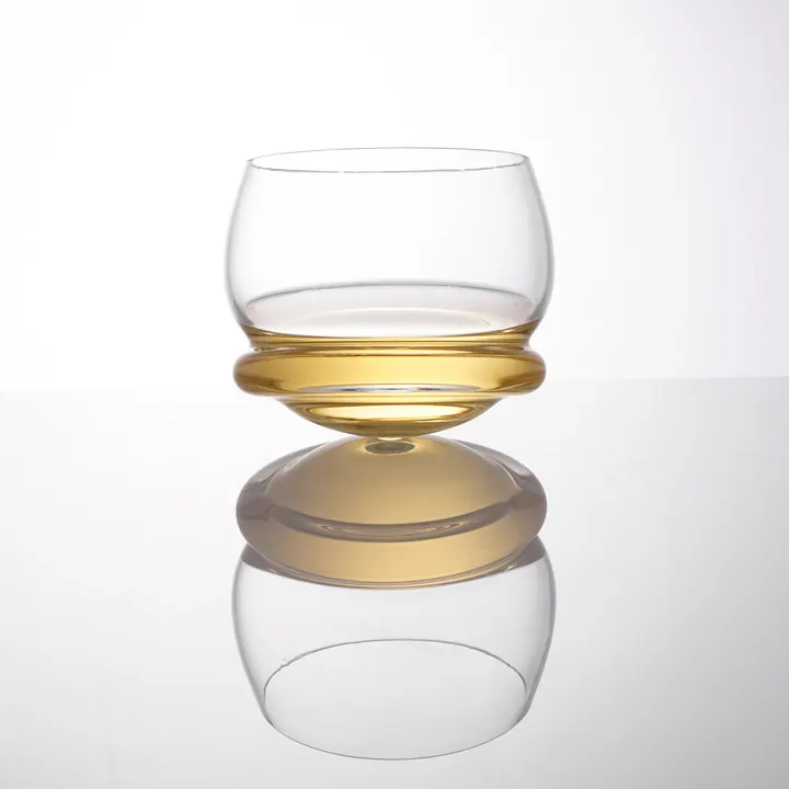 A rocking whiskey glass made from clear coloured crystal with whiskey